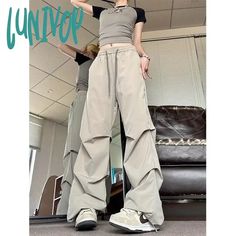 Lunivop Vintage Parachute Pants Women Black Baggy Y2k Streetwear Korean Fashion Pleated Cargo Trousers Harajuku 90s Aesthetic Kpop Season: All season Waist Type: high 1Measurement In CM size Waist(cm) Hips (cm) Pant Length(cm) M 64 90 101 L 66 92 102 XL 68 94 103 XXL 70 96 104 XXXL 72 98 105 1. The size is Asian size, smaller than US, UK, Australia, EU size. Please choose larger size or tell us your height and weight, and we suggest a suitable size for you. 2. The data is manually tiled measurem Y2k Streetwear Bottoms, Y2k Baggy Pants For Streetwear, Y2k Baggy Streetwear Pants, Y2k Wide Leg Streetwear Pants, Black Y2k Parachute Pants, Y2k Style Cargo Pants, Baggy Y2k Parachute Pants With Straight Leg, Spring Y2k Cargo Pants For Streetwear, Y2k Style Spring Cargo Pants For Streetwear