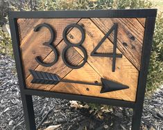 a wooden sign with an arrow pointing to the number 38 and three arrows on it