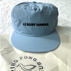 New, Grey/Blue, Le Surf Hawaii Hat. Check Out This Brand Online, Quality Craftsmanship, Made In Limited Quantities. Specialty Hat Bought Directly From The Founder Of Le Surf, But It Didn't Fit My Head/Hair Style. Hope To See It Go To A Good Home Surf Merch, Green 5-panel Trucker Hat For Beach, Cotton 5-panel Trucker Hat For Beach, Beach-style Trucker Hat With 5-panel Design, Blue 5-panel Snapback Hat For Beach, Blue 5-panel Trucker Hat, Hawaii Surf, Surf Accessories, Head Hair