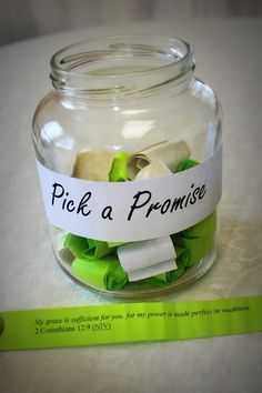 a glass jar filled with green and white paper