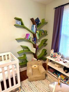 a baby's room with a tree shaped book shelf