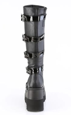 Shake it, baby! The Demonia SHAKER-210 knee-high boots are the sexiest platform boots around with a wedge platform that's just the perfect height to wear every day! They feature a cool heart shield buckle strap detail with chrome studs. Vegan Black patent leather 4 1/2 inch wedge Knee High Side zip U.S women's sizing-refer to size chart for more info Demonia Shaker, Emo Boots, Platform Knee High Boots, Demonia Boots, Demonia Shoes, Platform Flats, Black Platform Boots, Knee High Leather Boots, Black Platform