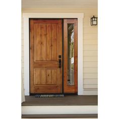 a wooden door on the side of a house