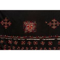 This fabulous antique Kohistani shawl whispers stories of the Mangal people, inhabiting the borderlands of eastern Afghanistan and western Pakistan. This antique shawl was Traditionally worn by women as a head covering during wedding or ceremonies, this piece is a testament to the Mangal's artistry and cultural heritage. Hand-crafted from heavy black cotton, the shawl is adorned with intricate silk embroidery. Geometric and floral motifs in vibrant colors like red, green and yellow dance across Ceremonial Shawl With Embroidered Border And Traditional Drape, Ceremonial Shawl With Embroidered Border, Traditional Dupatta Shawl With Border, Traditional Dupatta With Border In Shawl Shape, Traditional Pashmina Dupatta For Ceremonial Use, Traditional Shawl Shaped Dupatta With Border, Traditional Shawl-style Dupatta With Border, Traditional Pashmina Dupatta For Ceremonial Occasions, Pashmina Dupatta With Traditional Patterns For Ceremonies