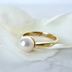 Simple 14k Yellow Gold straight shank with a 7mm Akoya Japanese Cultured White Pearl. Simple, feminine, and classic-perfect promise or engagement ring for your special someone.  7.25mm Fine Cultured Pearl Super lustrous White round pearl,  with rose, and slight green overtones 14 Karat Yellow Gold Ready to ship in size 6- sizable :: In the PERSONALIZED SECTION please enter your ring size and if you have any specifications, time frames, and or change of address We NOW offer Vintage Jewelry from o Classic Pearl Ring With Prong Setting For Formal Occasions, Minimalist Solitaire Pearl Ring For Formal Occasions, Classic Jewelry For Promise Ring With Tension Setting, Classic Round Pearl Ring For Formal Occasions, Classic Formal Pearl Ring With Prong Setting, Yellow Gold Rings With Classic Cut For Gift, Formal Classic Pearl Ring With Prong Setting, Classic Jewelry With Timeless Design For Anniversary, Classic Timeless Jewelry For Anniversary