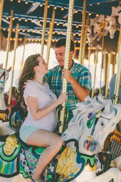 a man and woman sitting on a merry go round