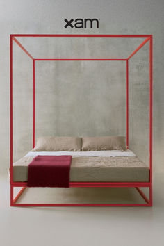 a bed with a red frame on top of it next to a sign that says xam