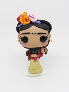 a figurine of a woman with flowers on her head holding a baby doll