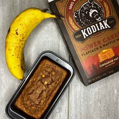 a banana next to a loaf of bread and a package of kodiak power cakes