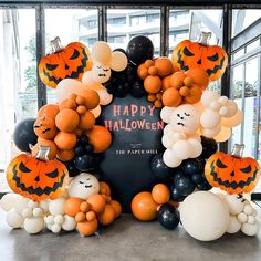 balloons and decorations are arranged around a halloween sign