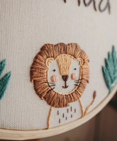 a close up of a pillow with a lion on it