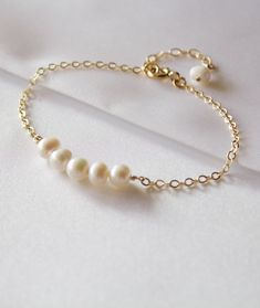 White Feminine Bracelets For Wedding, Elegant Adjustable Bridesmaid Bracelets, Feminine Pearl Bracelet For Wedding, Elegant Bridesmaid Bracelets, Elegant Gold Bracelets As Wedding Gift, Elegant Gold Bracelets For Wedding Gift, Elegant White Bracelet For Bridal Shower, Adjustable Pearl Bracelet For Wedding, Elegant Bracelet Jewelry For Bridesmaid Gift