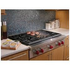 a stove top oven sitting in a kitchen next to a counter with food on it