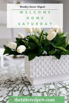 a white vase filled with flowers on top of a table