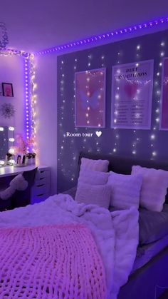 a bedroom decorated in purple and white with fairy lights