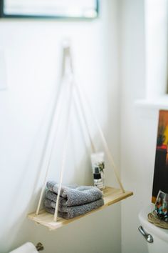 two towels are hanging on a shelf in the bathroom