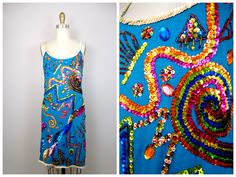 "This is a RARE vintage party dress! It's completely hand embellished with multicolored sequins and beads in a variety of abstract designs. SO amazing! It's in perfect condition! Measurements are taken unstretched and stretched. Bust - 36-40\" Waist - 32-36\" Hips - 36-40\" Length - 35\" This dress comes from a pet-free and smoke-free home. If you would like more info or have any questions, please don't hesitate to ask!" Fitted Embellished Festival Dress, Blue Fitted Dress For Festival, Multicolor Sequin Summer Dress, Summer Festive Sequin Dress, Summer Multicolor Sequin Dress, Summer Sequin Embellished Dress For Costume Party, Multicolor Festival Dress For Party Season, Embellished Multicolor Sequin Dress For Summer, Multicolor Embellished Sequin Dress For Summer