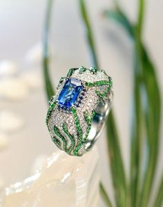 * Condition: Brand new * Center Stone: Natural Blue Sapphire, Emerald Cut, approx 2.08ct * Side Stone: Natural Tsavorite & Natural White Diamonds, round cut * Ring weight: 17.35g (actual weight depends on the ring size) * Metal Purity: 18K Solid White Gold (Optional) * Free DHL Express shipping. * Attached with Certificate. * Each piece is made-to-order with care and special attention to detail. all items are made with conflict-free diamonds and gems. * The item will be gift wrapped and shipped. Luxury Green Sapphire Ring With Accent Stones, Luxury Green Sapphire Ring With Diamond, Luxury Green Sapphire Jewelry, Luxury Green Sapphire Ring Gift, Luxury Green Sapphire Ring For Anniversary, Luxury Green Sapphire Anniversary Ring, Gold Engagement Ring Sapphire, Engagement Ring Sapphire, Luxury Jewelry Box