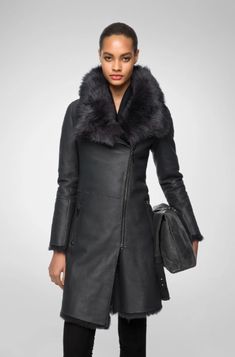 Women's Fur Shearling Leather Coat In Matte Black Experience the luxury of our women's fur shearling leather coat in matte black. Crafted from genuine sheepskin leather with a semi-aniline finish, this coat features a warm faux shearling inner shell. The design includes a zipper closure, a plush fur collar, and open hem cuffs for a sophisticated look. Practicality meets elegance with one inside pocket and two side zip pockets. This matte black coat offers a perfect blend of style and comfort for Leather Shorts Women, Leather Jumpsuit, Shearling Vest, Leather Industry, Studded Jacket, Distressed Jacket, Western Jacket, Suede Coat, Leather Shirt