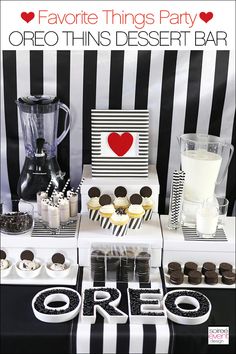 a dessert bar with cupcakes, cookies and milk on it for valentine's day