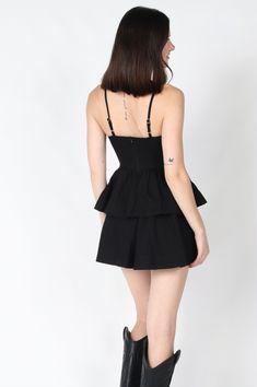 The Novie Mini Dress is your go-to little black dress for an unforgettable night out. Featuring delicate spaghetti straps and a playful tiered design, this sleek black dress effortlessly combines elegance with a hint of fun. Perfect for dancing the night away or making a statement at any evening event! Color: Black Self: 100% Cotton, Lining: 100% Cotton Hand wash cold, hang to dry. Item #2404-73LDJ Please call for in-store availability Size/Fit Model is wearing size S. Black Mini Dress With Adjustable Straps For Party, Black Suspender Dress With Ruffles And Spaghetti Straps, Black Ruffled Suspender Dress For Spring, Black Strap Mini Dress For Cocktail, Black Strappy Cocktail Mini Dress, Black Suspender Dress With Ruffles For Spring, Black Flirty Suspender Dress For Spring, Flirty Mini Dress With Adjustable Straps For Cocktail, Flirty Black Suspender Dress For Spring