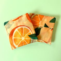 Carry your favorite fruit - and more - with this eye-catching reusable bag! Versatile enough for shopping, farmers markets, or the pool, its vibrant citrus design is perfect for summer. Reusable and reliable - it's the perfect bag for your everyday needs! And when you need to tuck it away, it folds down into the conveniently attached pouch to save space! This ripstop nylon shopping bag is approximately 16" wide and 25" tall when laid flat (including handles). Without handles, the bag portion is Eco-friendly Orange Beach Bag For Travel, Summer Reusable Grocery Bag, Reusable Grocery Bags For Summer, Orange Summer Bag For Gift, Eco-friendly Orange Beach Bag For Daily Use, Eco-friendly Orange Rectangular Beach Bag, Summer Orange Gift Bag, Orange Gift Bag For Summer, Orange Rectangular Reusable Bags