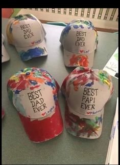 four hats with the words best dad ever written on them sitting on top of a table