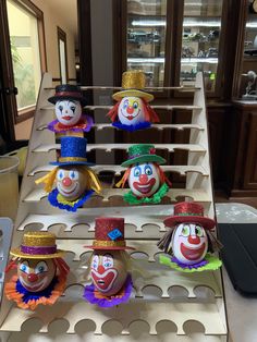 several colorful clown heads are on display in a store