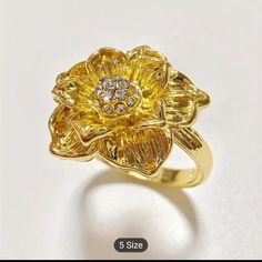 Beautiful 18k Gold Plated Flower Ring With Tiny Cz's In The Center. The Ring Is Very Shiny And Brilliant. Perfect As A Gift Or For Yourself. Nwt Elegant Gold-plated Flower Ring, Elegant Yellow Gold Cubic Zirconia Flower Ring, Elegant Gold Plated Flower Ring For Wedding, Elegant Yellow Gold Plated Flower Ring, Cubic Zirconia Yellow Gold Flower Ring, Gold Flower Ring With Diamond Accents, Yellow Gold Cubic Zirconia Flower Ring, Gold Diamond Flower Ring With Brilliant Cut, Gold Elegant Flower Ring For Promise