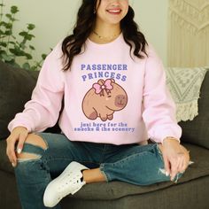 Get ready to be OBSESSED with your new Passenger Princess Kawaii Capybara Shirt. It's the cutest and most trendy way to emit all those important passenger princess and coquette ~vibes~! This is the perfect answer to: "I want preppy stuff"! * Q U I C K * F A C T S * ★ Gildan Crewneck Sweatshirt ★ Medium-heavy fabric blend of 50% cotton and 50% polyester  ★ The classic fit along with the crewneck line deliver a comfy wearing experience with a clean-cut style.  ★ Fabric blends: Heather Sport colors - 60% polyester, 40% cotton ★ Wash and dry normally (on cool for best results) * S I Z I N G * ★  Models are wearing size L-XL  ★ Sizing is unisex so runs like men's, though not overly large ★ Most women find their typical size works best, since they are meant to fit a touch loose ★ Please see size Cotton Kawaii Sweatshirt For School, Kawaii Cotton Sweatshirt For School, Cute Pink Sweatshirt For School, Pink Kawaii Top With Funny Print, Kawaii Funny Print Crew Neck T-shirt, Pink Kawaii Hoodie Sweatshirt, Kawaii Capybara, Pink Kawaii Sweatshirt, Coquette Vibes