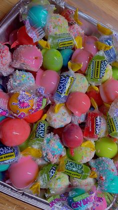 an assortment of candy candies in a plastic container