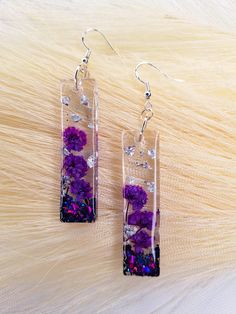 Each earring is hypoallergenic and made from sterling silver  Made from real flowers This design is 2 inch by 1/2 in diameter Diy Resin Projects, Resin Projects, Charm Necklaces, Diy Resin, Purple Flower, Resin Diy, The Purple, Real Flowers, Purple Flowers