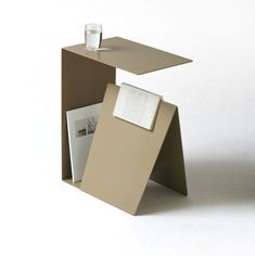 an open cardboard box sitting on top of a table with papers and a cup next to it