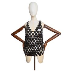 An instantly recognisable, Iconic Paco Rabanne Chain Mail Vest. Crafted in Madagascar from Black Star shaped Plastic discs with Silver coloured brass attachments. The Vest can be worn on a variety of sizes due to the Loose nature of the garment, we would recommend UK 6-12. Measurements taken laid flat in Inches - Pit to pit : 20" Shoulder to hem : 22" Great Used Condition with no obvious signs of distress or wear. 1960s Paco Rabanne, Black Chainmail, Pack Rabanne Dress, Vintage Paco Rabanne Dress, Paco Rabanne Chainmail, Paco Rabanne 1969 Bag, Mesh Vest, Paco Rabanne, Chain Mail