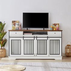 a flat screen tv sitting on top of a wooden cabinet