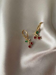 These small beautiful earrings are available plated in real 18k gold, the cherry is made of AAA cubic zirconia gems!  Sold as a pair! Matching necklace sold separately: https://www.etsy.com/uk/listing/916466685/silver-gold-cherry-necklace-gold-filled?ref=shop_home_active_10&frs=1&sca=1  DETAILS * high quality rhodium with 18k gold plating  * non tarnish and waterproof  * classic and super trendy  * 18k gold plating * Cubic zirconia cherry  * Length: 25 mm  We also have these huggies in silver! https://www.etsy.com/uk/listing/916603705/silver-cherry-earrings-white-gold-plated? ref=shop_home_active_2&frs=1  PACKAGING Each piece is beautiful wrapped up in tissue paper, sealed with a branded sticker, then gifted in a complimentary cute pouch, perfect for safekeeping and gifting.  DELIVERY UK o Cherry Necklace, Cherry Earrings, Huggie Earrings, Hypoallergenic Earrings, Matching Necklaces, Jewelry Earrings Hoops, Huggies Earrings, Beautiful Earrings, Diy Jewelry