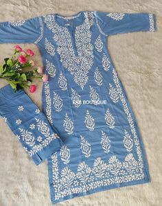 Description ▪ Kurti Fabric: Modal Cotton ▪ Kurti Length: 46-48 Inches ▪ Pant Fabric: Modal ▪ Pant Length: 38-40 Inches ▪ Sleeves : 3/4 Sleeves ▪ Style : Straight Kurti ▪ Occasions : Casual Wear, Office Wear, Festive Wear ▪ Garment Care : Hand Wash Only ▪ Price Includes : 1x Kurti, 1x Pant Disclaimer: Embroidery may be little vary due to various human hand involvement. Delicate Chikan hand embroidery on the cotton fabric. This kurti is the epitome of class and beauty. Tailored in straight fit; th Blue Cotton Anarkali Set With Floral Embroidery, Traditional Chikankari Diwali Dress, Traditional Chikankari Embroidery Dress For Diwali, Traditional Diwali Dress With Chikankari Embroidery, Traditional Chikankari Dress For Diwali, Fitted Chikankari Embroidery Dress For Navratri, Summer Designer Chikankari Embroidered Dress, Summer Designer Embroidered Dress With Chikankari, Cotton Straight Kurta With Intricate Embroidery