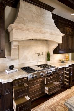 a kitchen with an oven, stove and sink in it's center island area