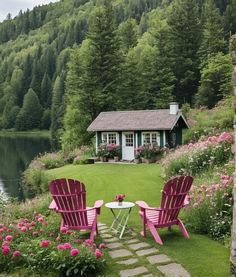 two lawn chairs sitting on top of a grass covered field next to a lake and forest