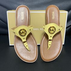 Brand New Michael Michael Kors, The Conway Leather Sandals Feature: Leather Upper Slip-On Styling Padded Insole Synthetic Lining Rubber Outsole Size: 8 Or 9 Color: Buttercup Gold Flat Sandals With Cushioned Footbed, Gold Synthetic Sandals With Single Toe Strap, Gold Sandals With Single Toe Strap, Gold Sandals With Leather Footbed And Flat Heel, Leather Footbed Flat Flip Flops, Gold Leather Heels For Vacation, Gold Cushioned Flip Flops For Spring, Gold Leather Flat Flip Flops, Gold Toe Post Sandals With Cushioned Footbed