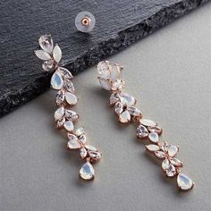 CZ and Opal Crystal Drop Earrings in Rose Gold You'll adore wearing these gorgeous rose gold plated bridal earrings sparkling with brilliant 5A quality Cubic Zirconia and opal crystals. These stunning earrings feature glistening marquis and pear shaped crystals for fabulous sparkle. Size: 3 1/8" long and 7/16" wide. Color: Rose Gold/Opal/Clear. Style: 4599EO-RG. Need several pair of earrings for your wedding party? You can buy in bulk and save! Please allow about a week for delivery. Shipping Po Wedding Dangle Earrings, Rose Gold Dangle Earrings, Earrings For Bride, Dangle Earrings Wedding, Jewelry Showcase, Prom Earrings, Simple Accessories, Vintage Inspired Jewelry, Gold Jewelry Earrings