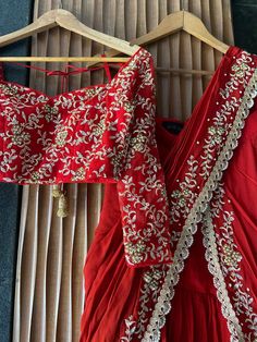 A two-piece red pre-stitched saree set from the Priti Sahni collection. This gorgeous red georgette pre-stitched ruffled saree with pearl and zardozi rose gold hand embroidery and scalloped edging is paired with a red net embroidered tie-up blouse. Festive Party Wear Pre-draped Embroidered Saree, Red Semi-stitched Pre-draped Saree With Resham Embroidery, Red Embellished Georgette Sharara, Red Pre-draped Saree For Reception At Eid, Red Embellished Floor-length Saree, Red Pre-draped Saree With Unstitched Blouse For Reception, Elegant Red Sharara With Dori Work, Party Wear Embroidered Pre-draped Saree For Festivals, Red Pre-draped Saree With Dupatta For Reception