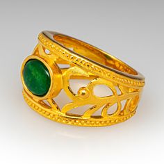 This lovely 24K gold ring is centered with one (1) natural jadeite jade that is bezel set. The ring features a cut out design with a sandblasted finish and polished edges. The ring measures 13.8mm at the top, rises 5.6mm above the finger, tapering to 5.0mm wide and 1.7mm thick at the base of the shank. The ring is a size 6.25. We are not offering resizing due to the design of the ring. Brand Presentation, Ruby Birthstone, Jade Ring, Cut Out Design, July Birthstone, Ruby Jewelry, Oval Cabochon, Bezel Setting, High Quality Jewelry