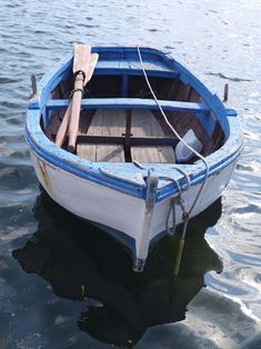 a small blue and white boat in the water