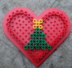 a red heart shaped christmas tree made out of legos