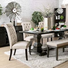 a dining room table with chairs and a bench in front of it on a rug