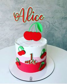 a white cake with red and green frosting on top that says alice mes