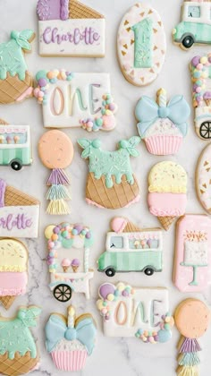 decorated cookies are arranged on a marble surface