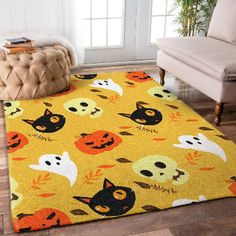 a yellow area rug with halloween themed cats, pumpkins and skulls on it in a living room