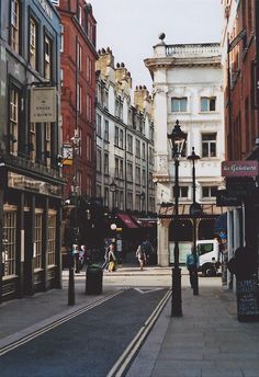 a city street with tall buildings on both sides